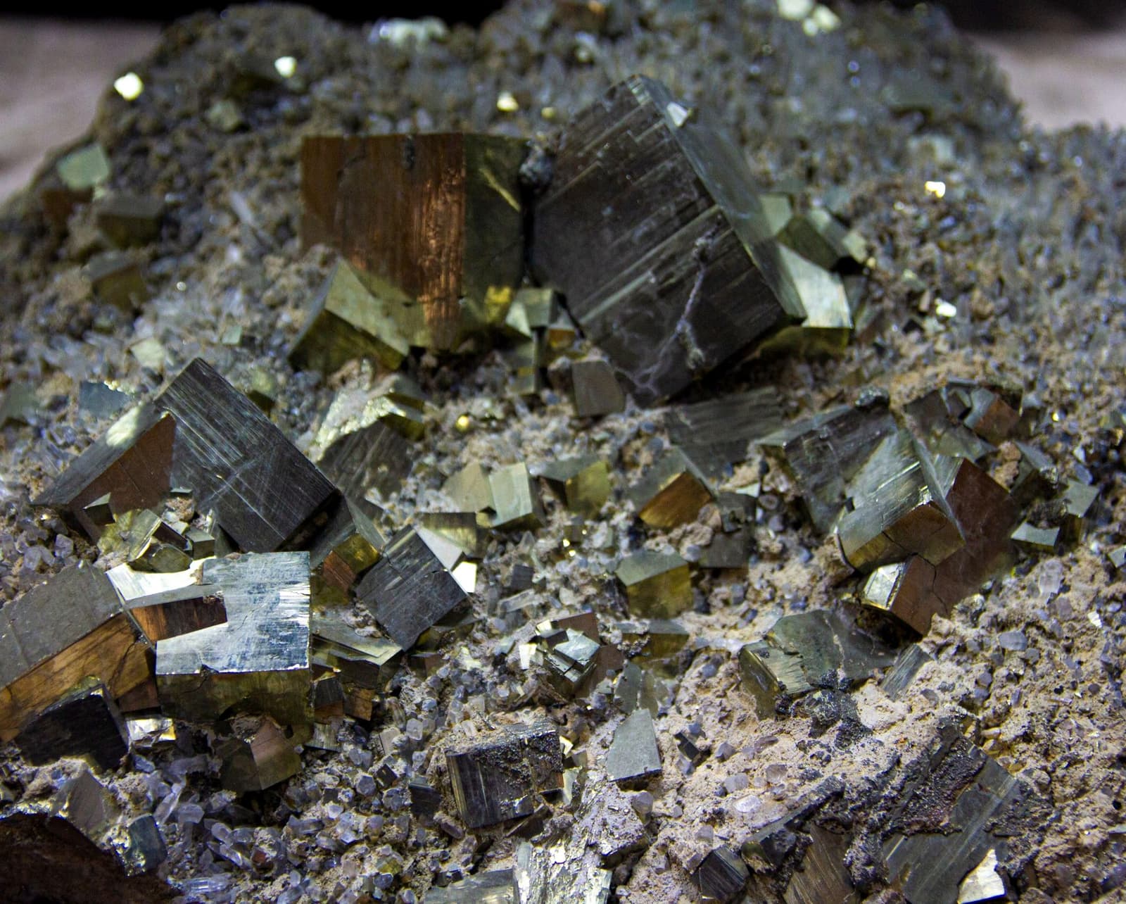 Close-up of pyrite crystals in rock, under the headline By-products