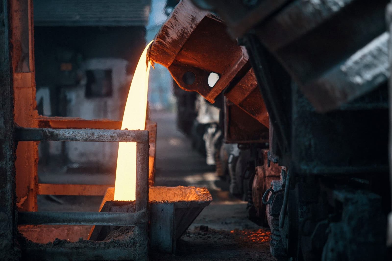 Molten metal pouring from a ladle into a mould, under the headline Concentrate vs Doré