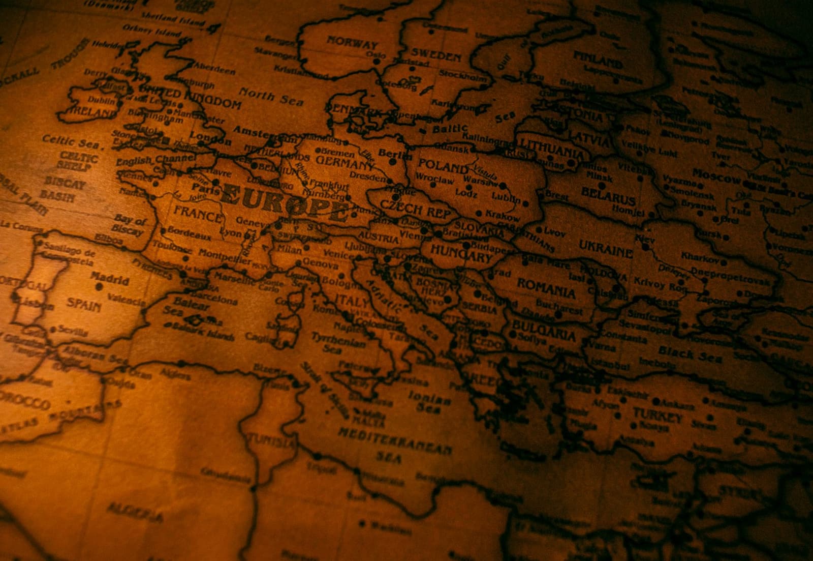 An old printed map of Europe in warm amber light, with country names across the centre, under the headline Frankfurt listings