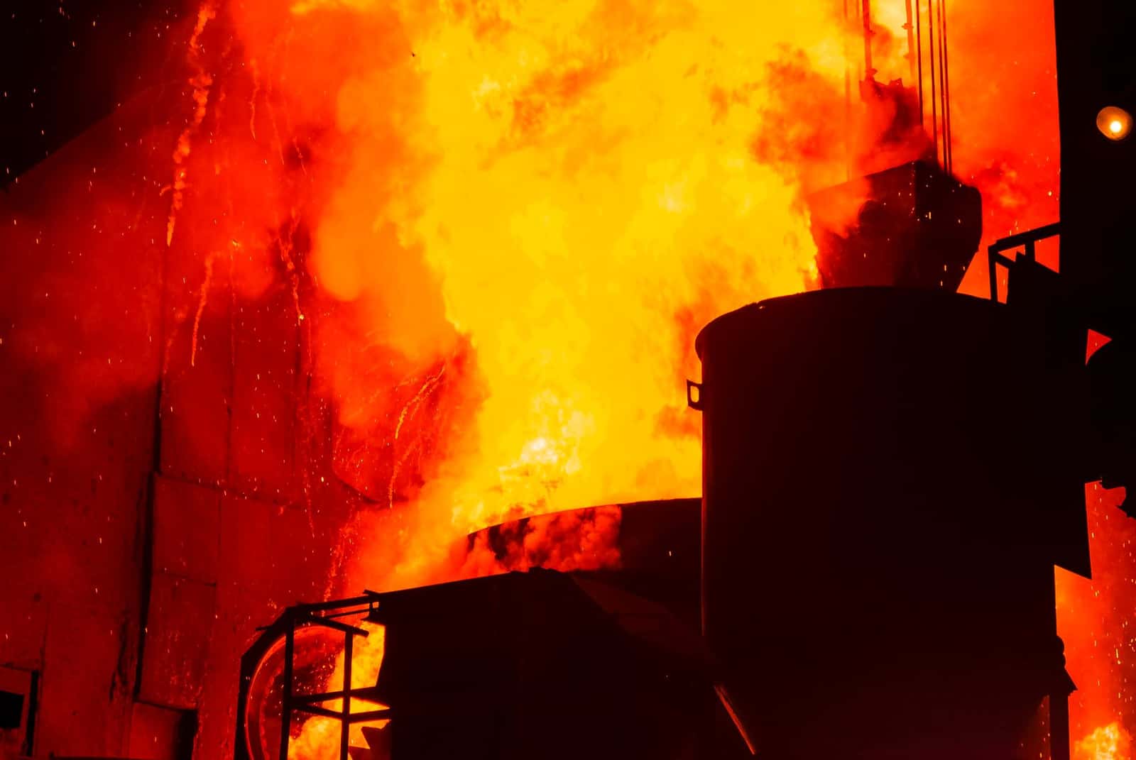 Fire and molten metal in a steel plant, under the headline Manganese