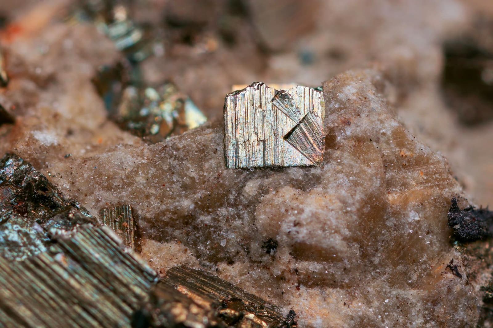 Close-up of metallic crystals sitting in grey rock, under the headline Metal equivalents