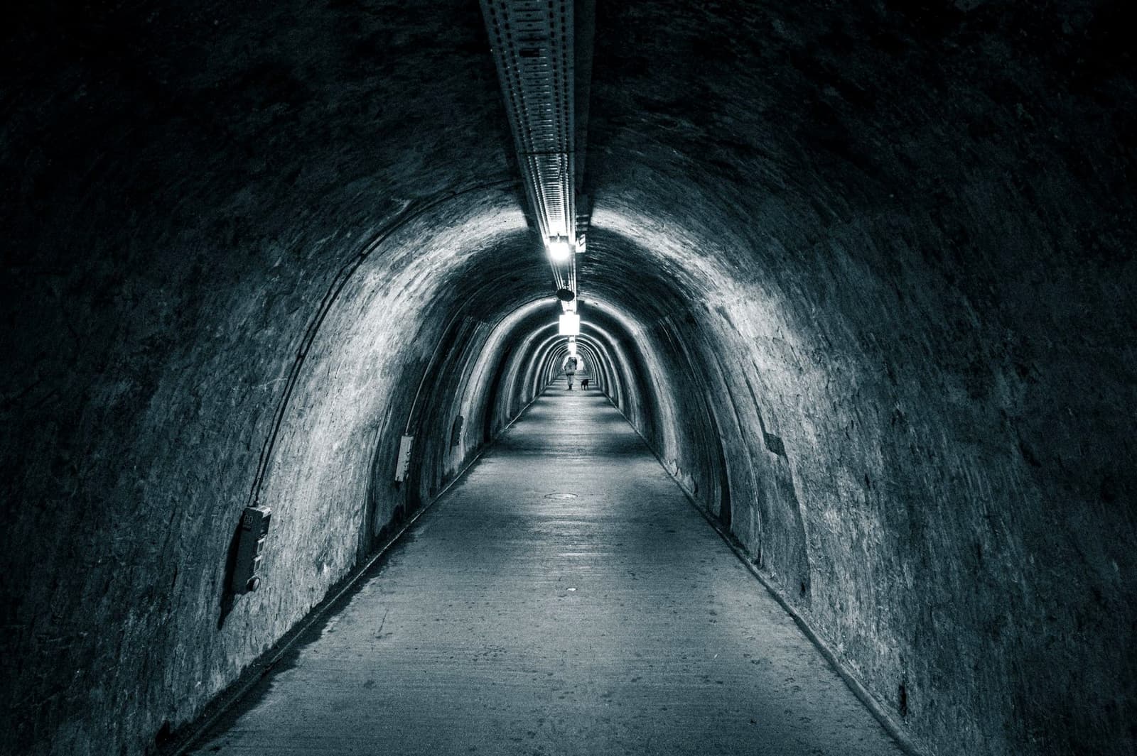 A lit underground tunnel, under the headline Pit or Portal
