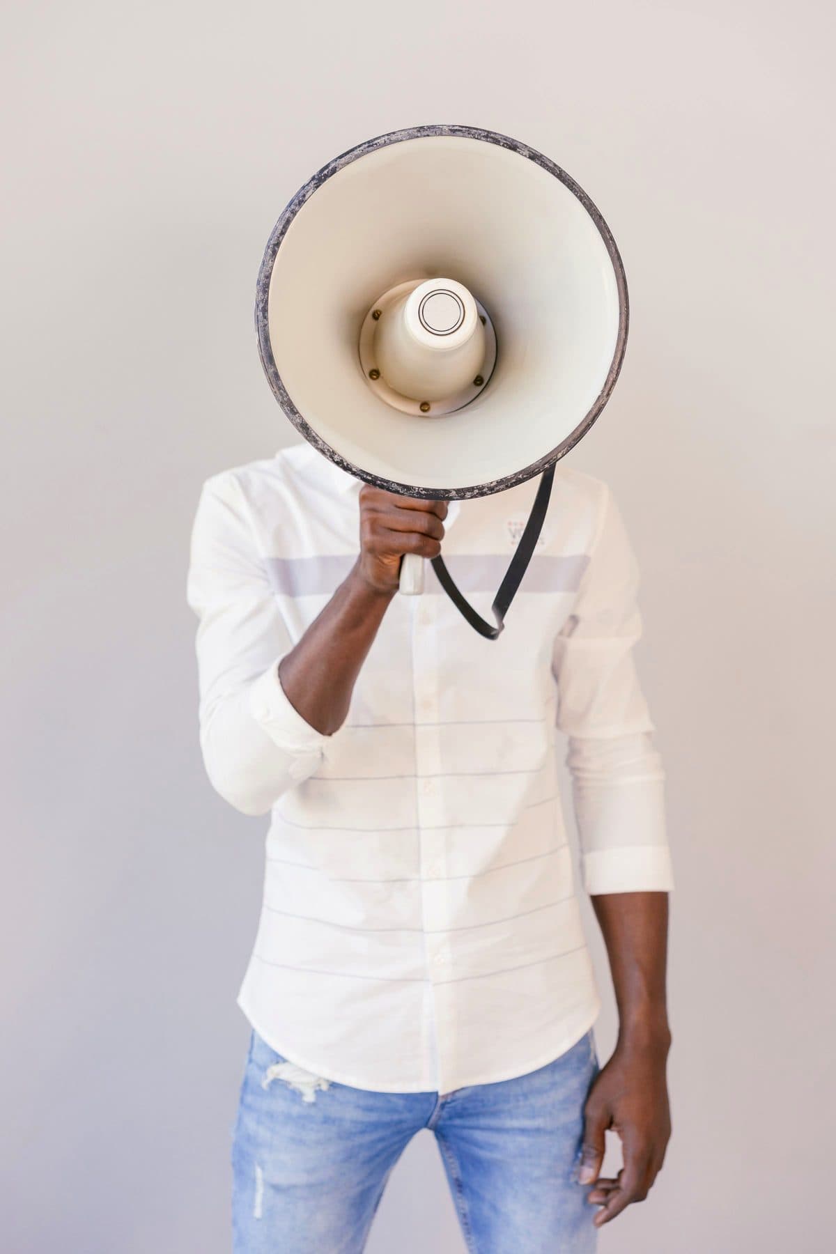 A person holding a megaphone in front of their face against a pale wall, under the headline Red flags