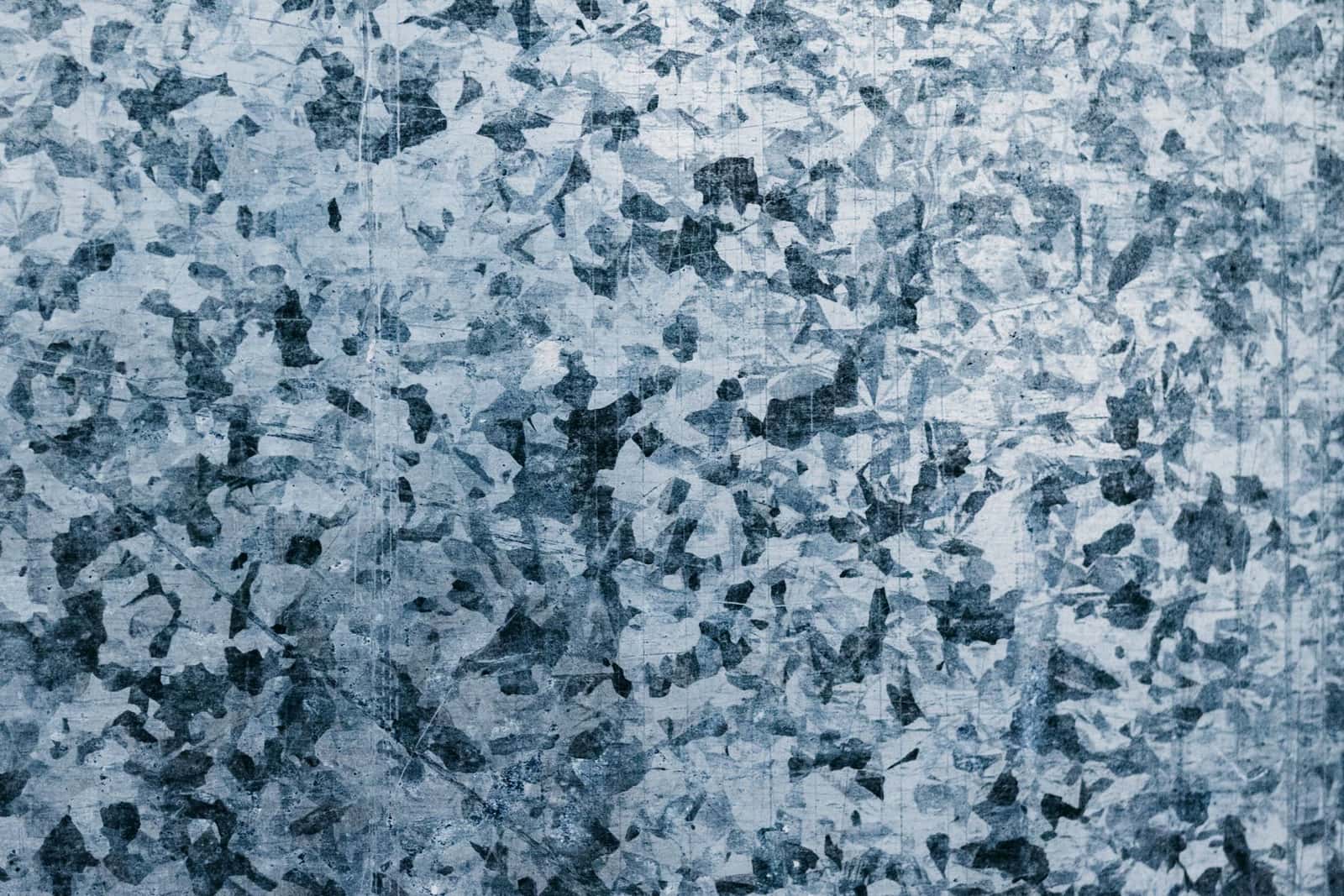 Close-up of the crystal pattern on galvanized (zinc-coated) steel, under the headline Zinc